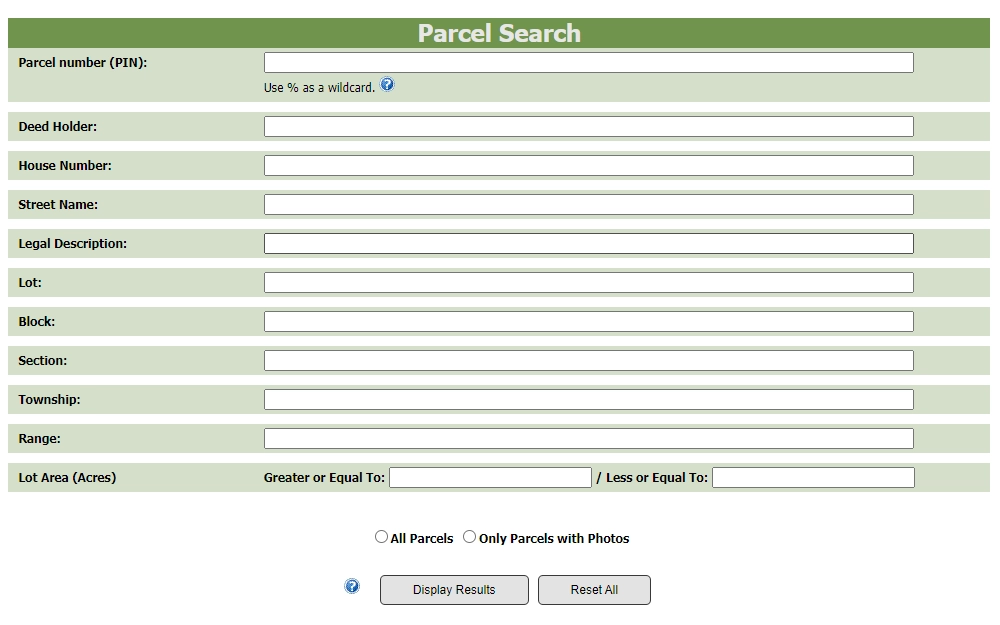 A screenshot of the parcel search page on the Ward County Director of Tax Equalization website displays the necessary search fields and filtering options.